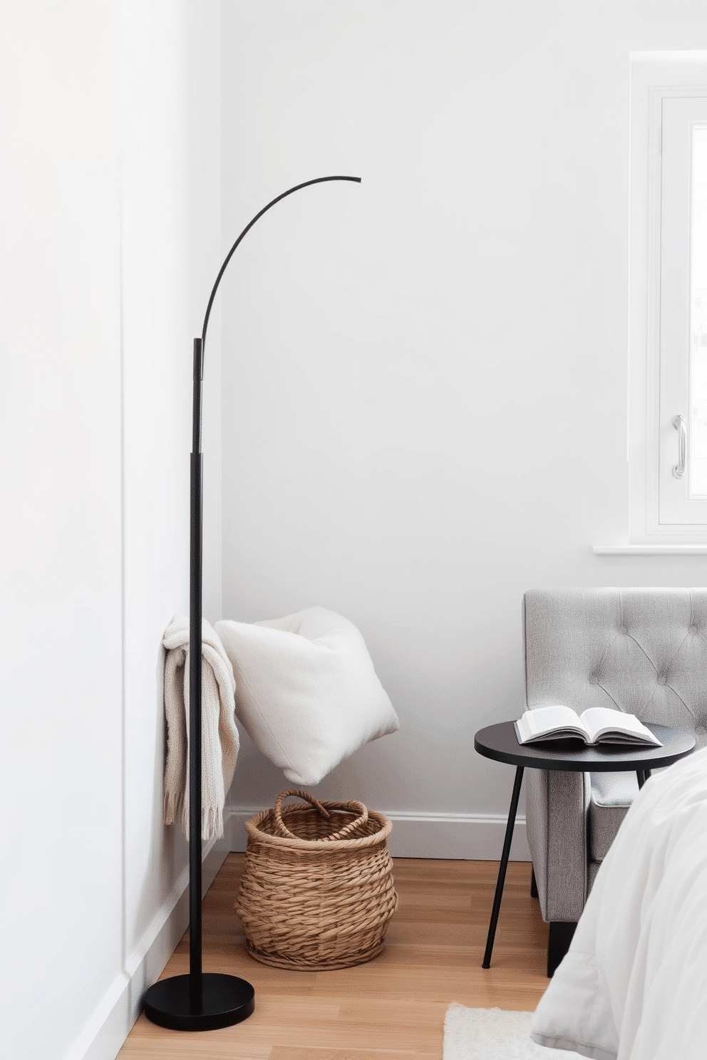 A minimalist Scandinavian bench crafted from light oak wood rests against a crisp white wall. Soft, neutral-toned blankets are casually draped over one side, paired with a small woven basket placed neatly on the floor beneath. A cozy bedroom reading nook features a tufted armchair in a soft gray fabric, positioned by a large window. A slim black floor lamp arcs overhead, illuminating a small side table with a single, open book placed on its surface.