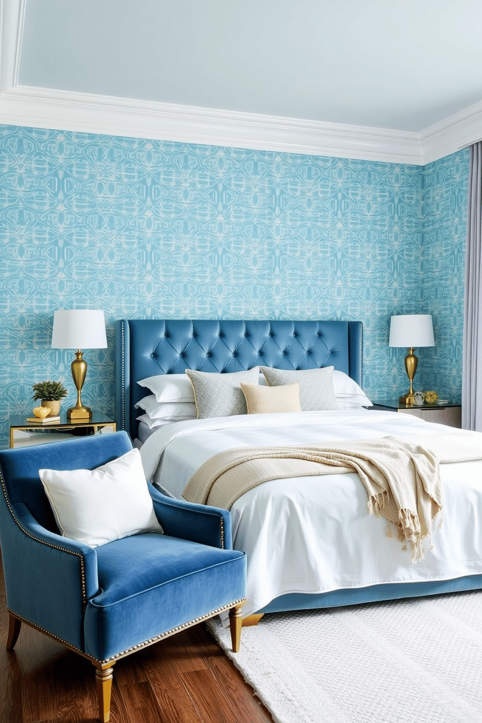 A serene bedroom adorned with ice blue wallpaper featuring intricate geometric patterns. The soothing backdrop is complemented by a plush upholstered headboard in a matching soft blue hue, paired with crisp white bedding. The layout is refined with gold-accented bedside tables and minimalist table lamps, adding a touch of elegance. A cozy armchair in navy velvet sits by the window, layered with a soft throw, while a textured white rug anchors the space.