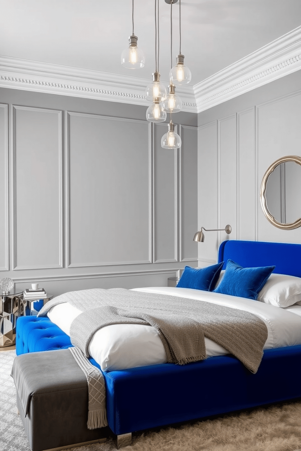 A luxurious bedroom with a rich cobalt bedframe as the focal point, featuring sleek velvet upholstery and a modern silhouette. Beside the bed, glass pendant lights with soft, warm illumination cascade from the ceiling, adding a touch of airy sophistication. The walls are painted in a soft gray tone, complementing the cobalt blue while creating a serene atmosphere. Accents of chrome and mirrored furniture enhance the room, while plush textiles in neutral and blue hues provide depth and layering.