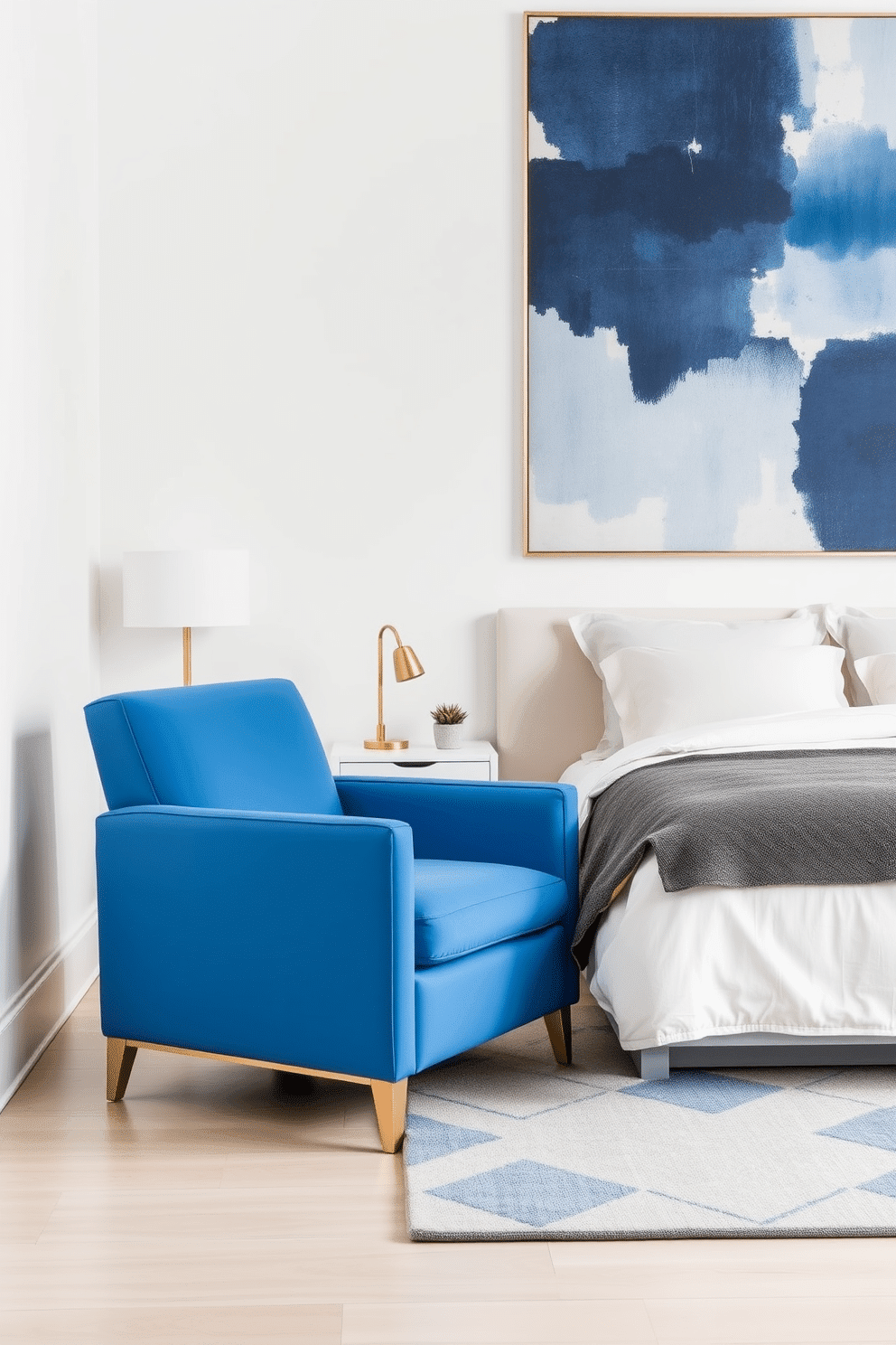 A sleek and modern bedroom with walls painted in crisp white, accentuated by a bold, bright blue accent chair featuring clean lines and a streamlined silhouette. The chair is positioned near a minimalist nightstand, with a gold reading lamp and a small ceramic planter adding subtle decorative touches. The bed features soft linen bedding in neutral tones, paired with an oversized geometric-patterned area rug in muted blues and grays for added texture. A large abstract art piece above the bed incorporates shades of blue, tying the room together with a balanced yet vibrant aesthetic.