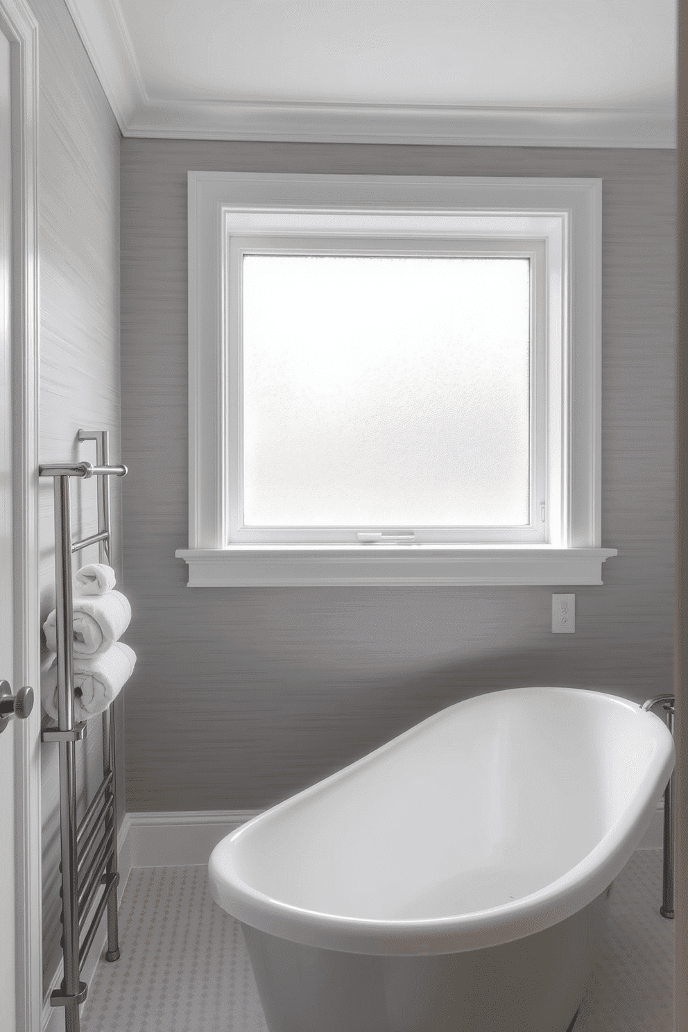 A serene gray bathroom featuring light gray textured wallpaper paired with crisp white trim, offering a delicate contrast. The wallpaper adds subtle depth to the walls, blending harmoniously with the minimalist décor. A freestanding bathtub rests gracefully near a large frosted glass window, filling the space with soft, natural light. Beside it, a sleek silver towel rack showcases rolled white towels, enhancing the elegant gray palette.