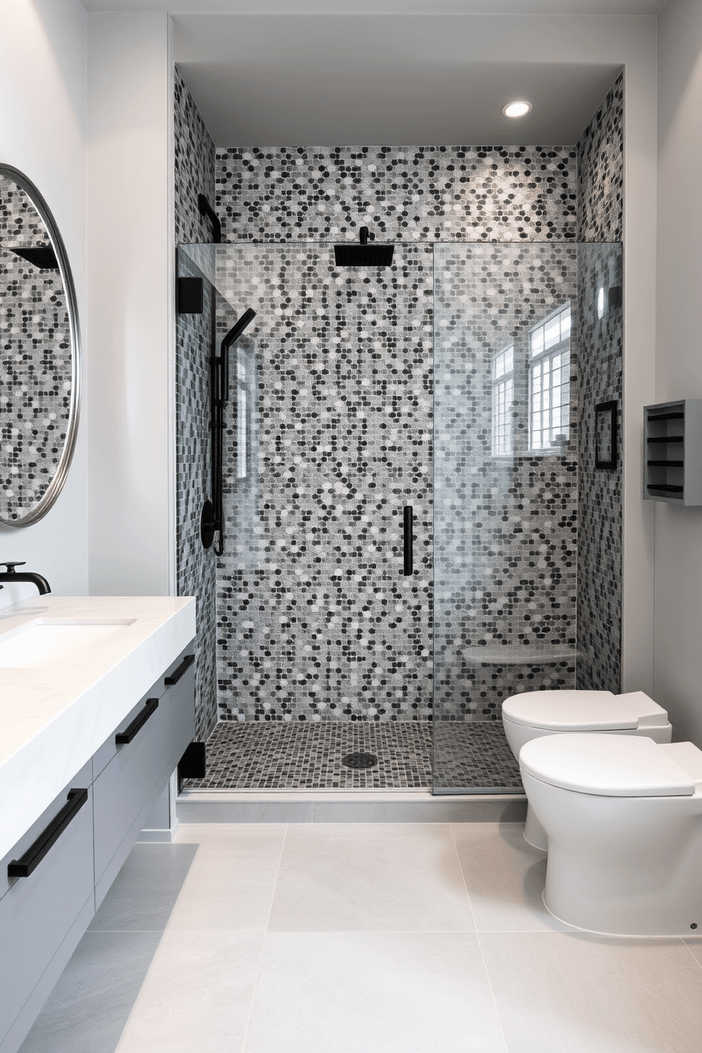 A serene bathroom retreat with gray mosaic tiles adorning the shower area, creating a textured and luxurious feel. The shower features sleek, matte black fixtures and a frameless glass door, enhancing the modern aesthetic. The floor is paved with large, light gray porcelain tiles that complement the shower's mosaic design. A floating vanity with a quartz countertop and a circular LED mirror adds a contemporary element to balance the muted gray tones.