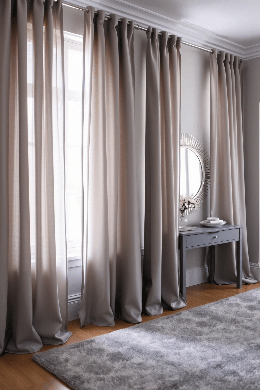 Layered gray curtains drape elegantly from a polished rod, providing both depth and privacy to the space. The soft fabric cascades down, creating a sophisticated ambiance while allowing gentle light to filter through. The foyer features a sleek gray console table against the wall, adorned with a stylish mirror that reflects the soft hues of the curtains. A plush area rug in varying shades of gray anchors the space, adding warmth and inviting texture to the entryway.