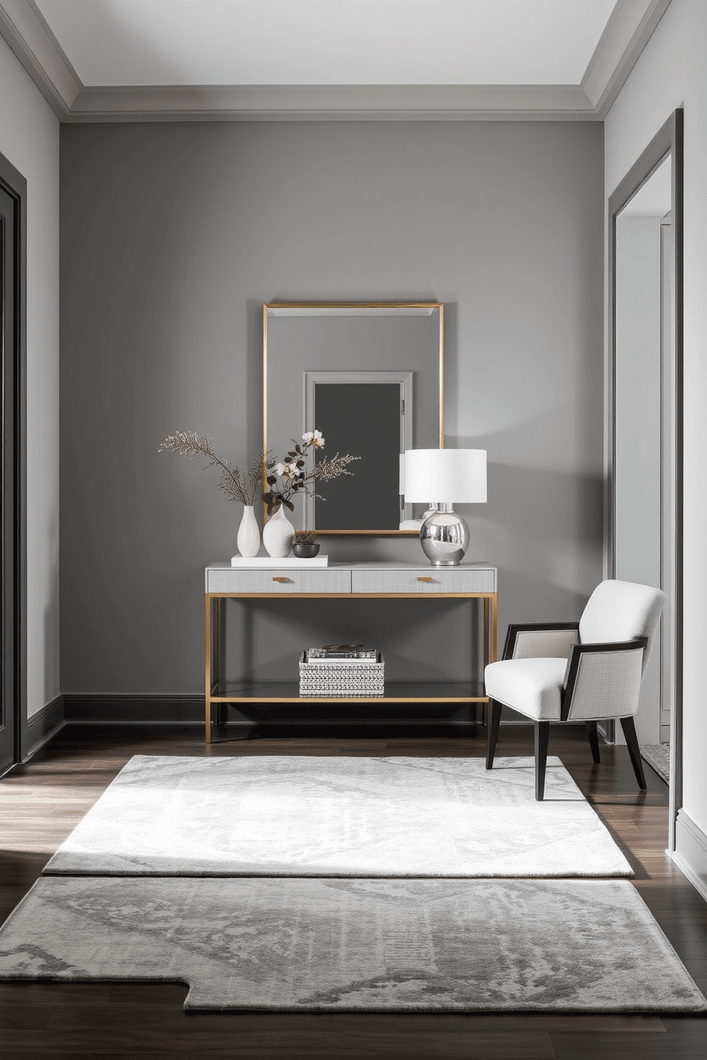 A stylish foyer adorned with layered gray rugs that add depth and texture to the space. The walls are painted in a soft gray hue, complementing the elegant design of the entrance. Incorporate a sleek console table against one wall, topped with decorative items such as a modern lamp and a small potted plant. A large mirror hangs above the table, reflecting light and creating a sense of openness in the foyer.