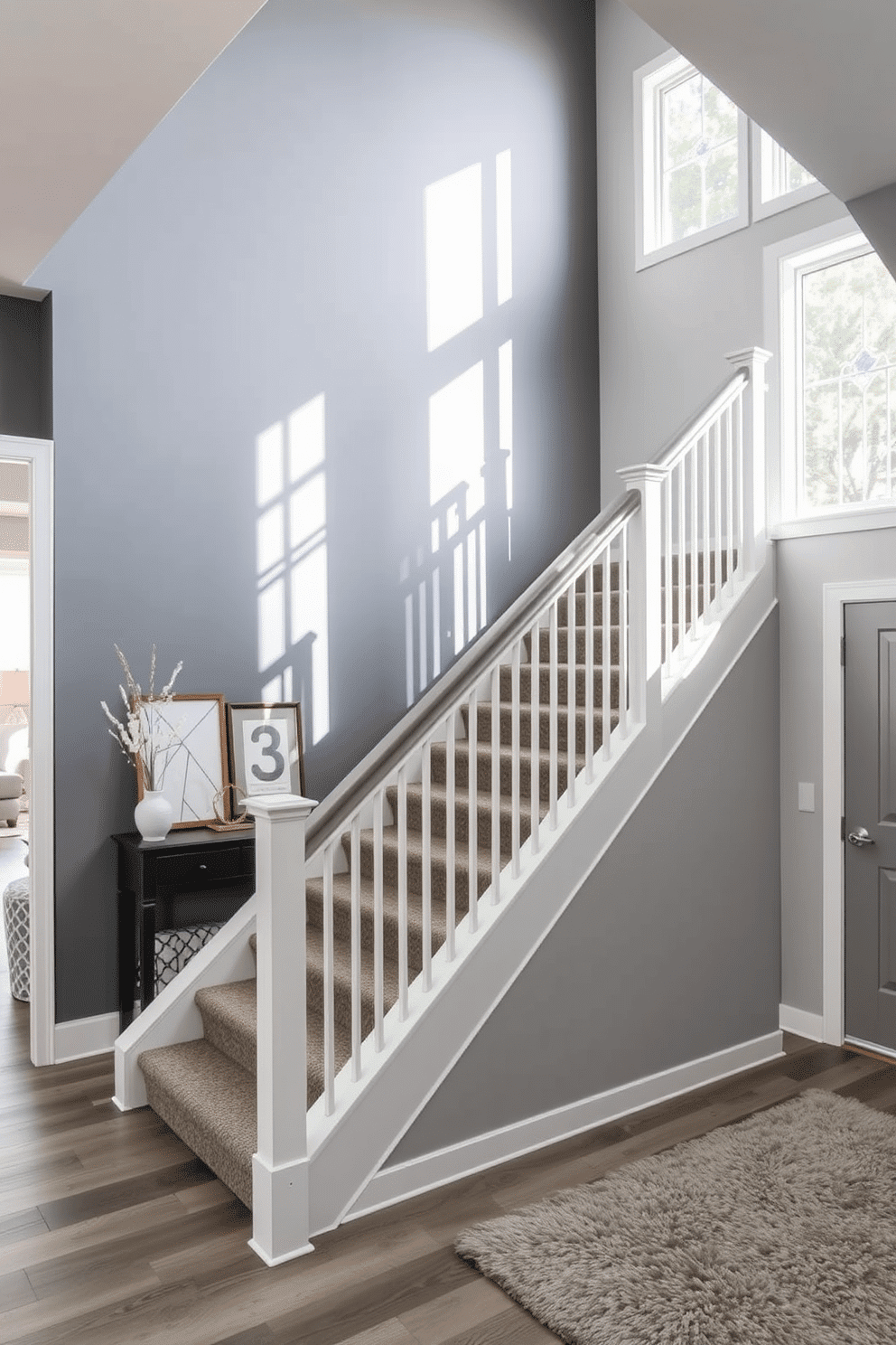 A striking gray accent wall serves as a dramatic backdrop for the elegant staircase, enhancing the overall aesthetic of the entryway. The staircase features sleek, minimalist railings and a plush runner that adds warmth and texture to the modern design. The gray tones create a cohesive look, seamlessly blending with surrounding decor elements. Natural light filters through nearby windows, casting soft shadows that highlight the architectural details of the staircase.