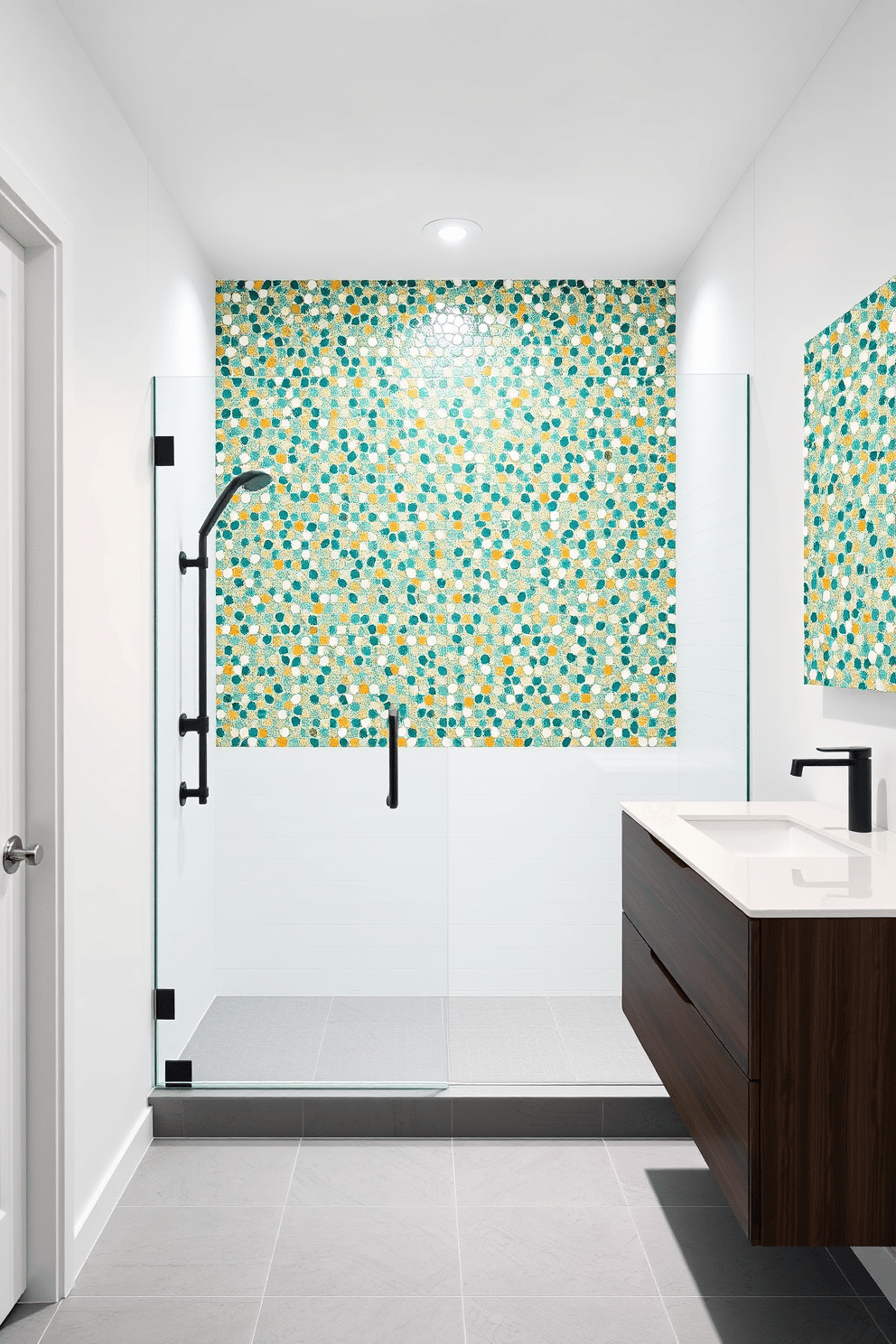 A striking bathroom with a bold mosaic feature wall, showcasing intricate patterns in shades of teal, gold, and white. The mosaic stretches across the main wall of the shower, creating a dazzling focal point that effortlessly elevates the space. The surrounding décor is kept minimal, with smooth white walls and a sleek glass shower door to emphasize the vibrant mosaic. A dark wood floating vanity and a matte black faucet complete the design, grounded by soft gray tiles on the floor.