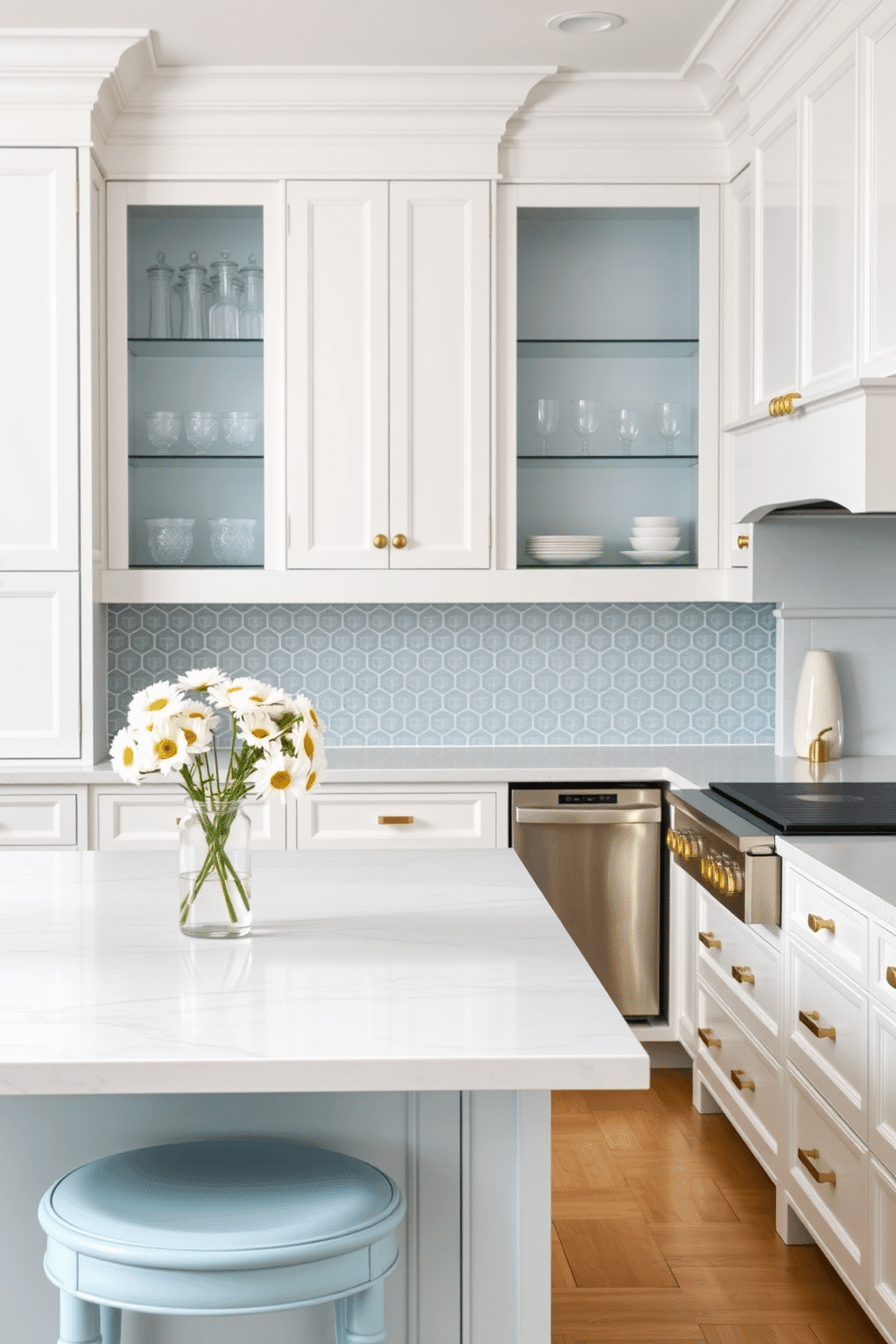 A serene and elegant kitchen with a snowy white color palette complemented by soft sky blue accents. The cabinets and countertops are a crisp white, while the backsplash showcases intricate sky blue tiles in a geometric pattern for subtle charm. A large island with a polished white marble surface serves as the centerpiece, with sky blue stools featuring gold hardware for seating. Floating sky blue shelves display neatly arranged glassware, and a vase with white daisies adds a fresh, natural touch near the sink.