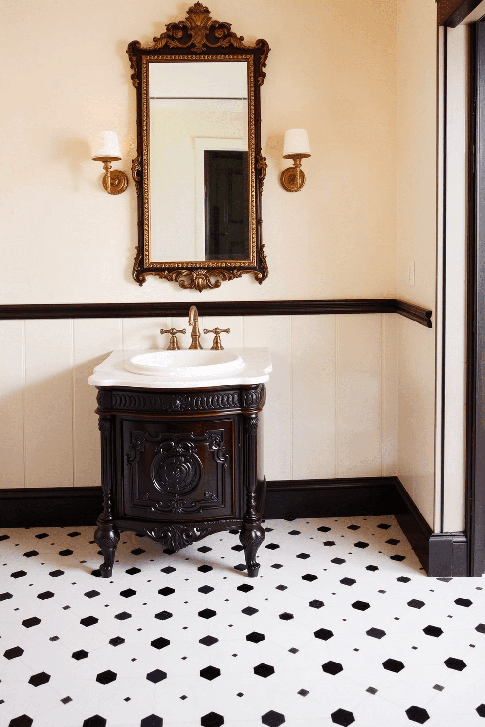 A charming Victorian bathroom setting. A dark wooden vanity with ornate carvings stands against a backdrop of soft cream walls, topped with a white marble countertop and an oval porcelain sink. The floor is adorned with classic black-and-white hexagon tiles, complementing the timeless appeal. Above the vanity hangs an antique brass-framed mirror, flanked by wall sconces casting a soft, golden glow.